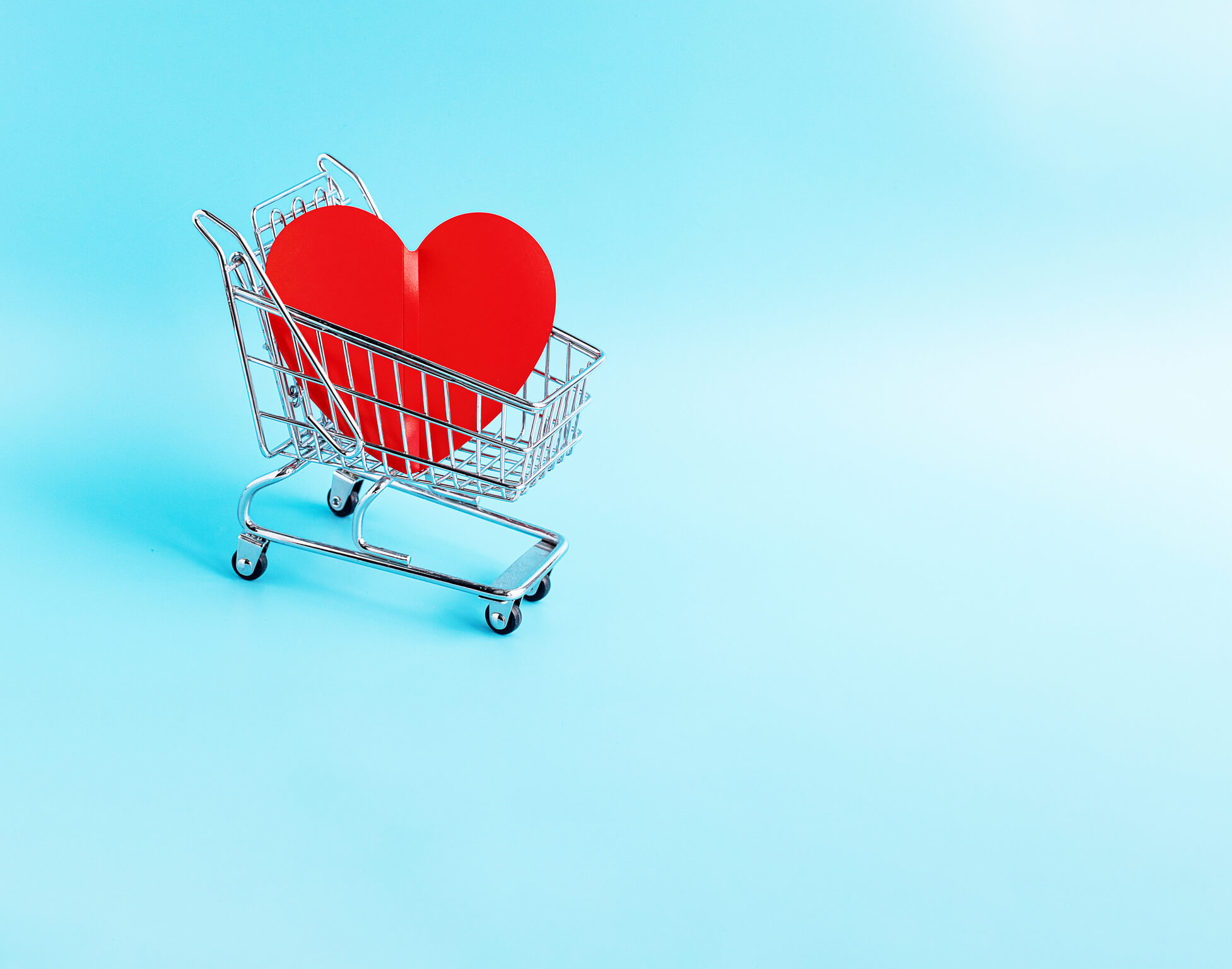 A shopping cart with heart inside it.