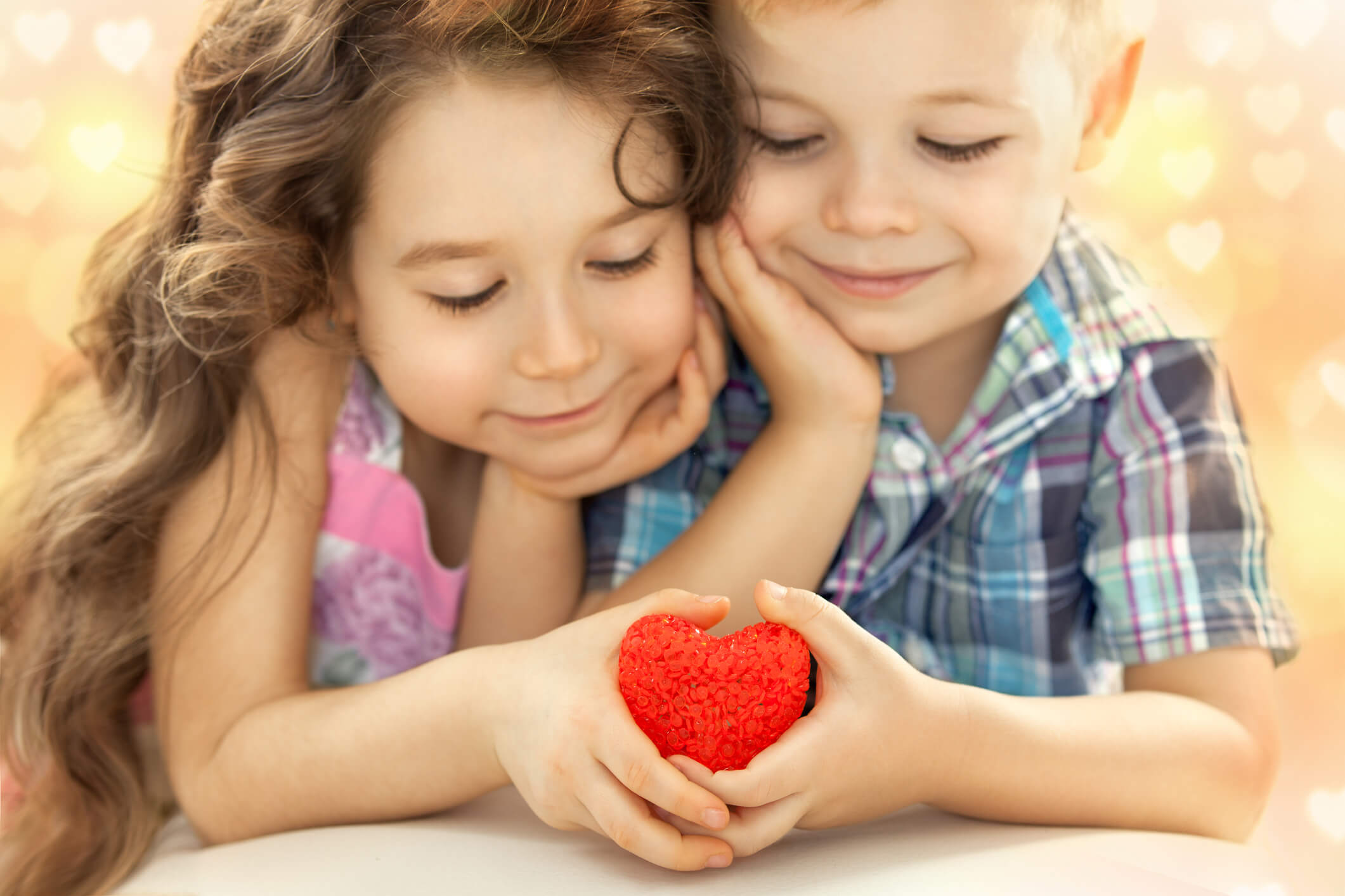 Two kids holding a red heart